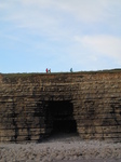 SX25199 People walking over cave in cliffs.jpg